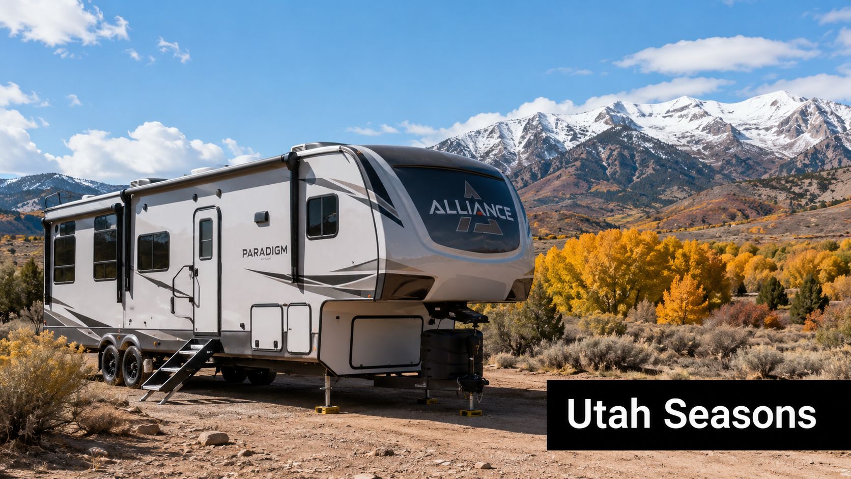 A luxurious Alliance Paradigm fifth-wheel travel trailer parked in a scenic Utah landscape with fall foliage.