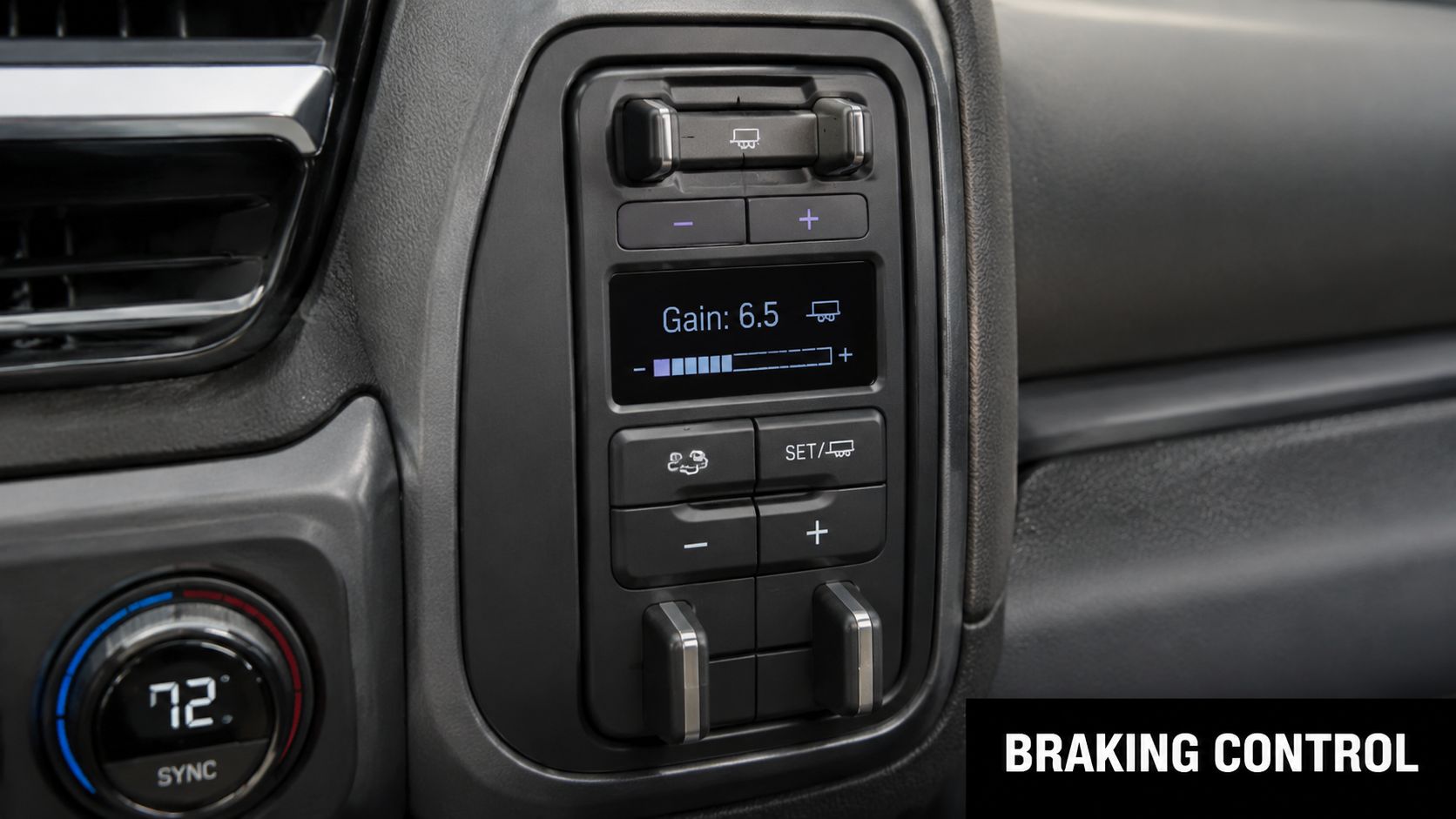 A close-up view of a truck interior featuring the electronic trailer brake controller display and buttons.