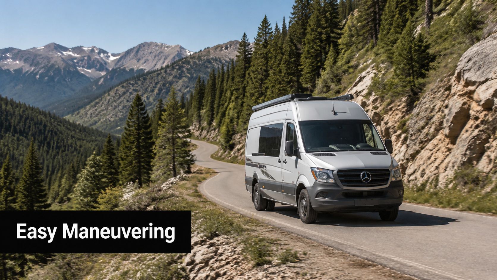 A silver Mercedes-Benz Class B motorhome driving on a scenic, winding road through a mountainous landscape.