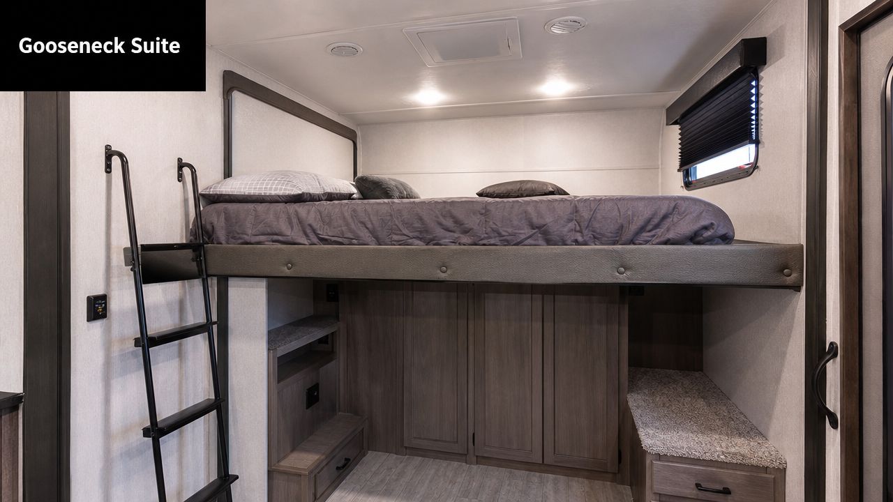 A cozy elevated queen bed setup inside a recreational vehicle toy hauler above storage cabinetry and steps.