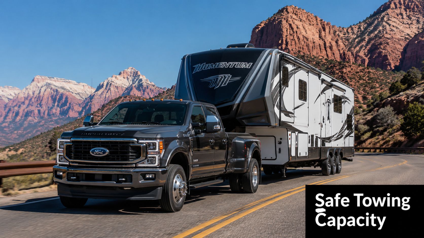 A black Ford Super Duty truck towing a large fifth-wheel Momentum RV on a mountain road.